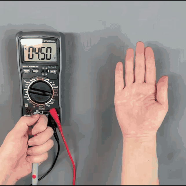 Testing grounding fitted sheet with digital multimeter, AC 04.50 reading