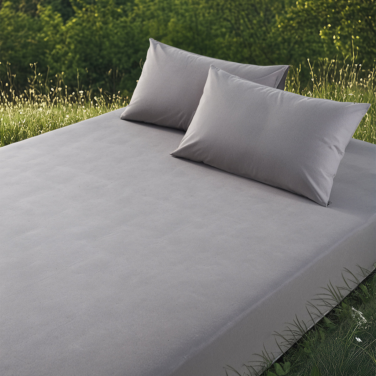Grey grounding bamboo fitted sheet and pillows, outdoor setting